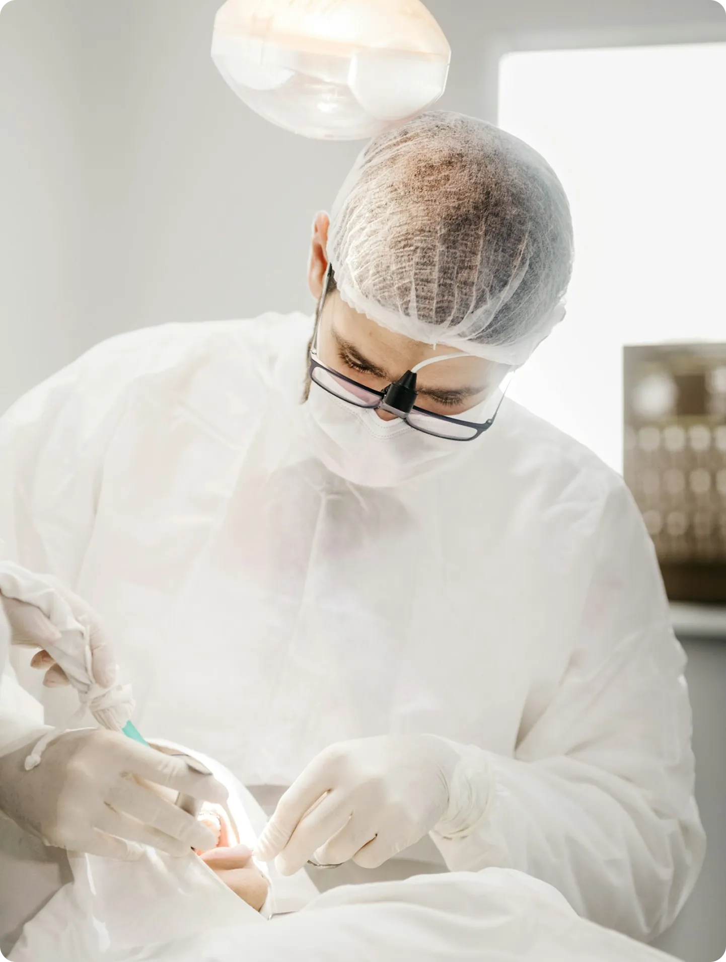 Dentist wearing surgical gloves and a face mask performing a dental procedure