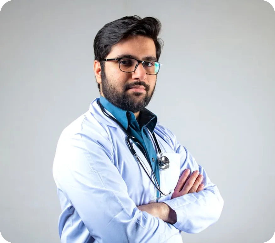 Dr. Jhosom Matt Patel standing with arms crossed in a white coat and stethoscope